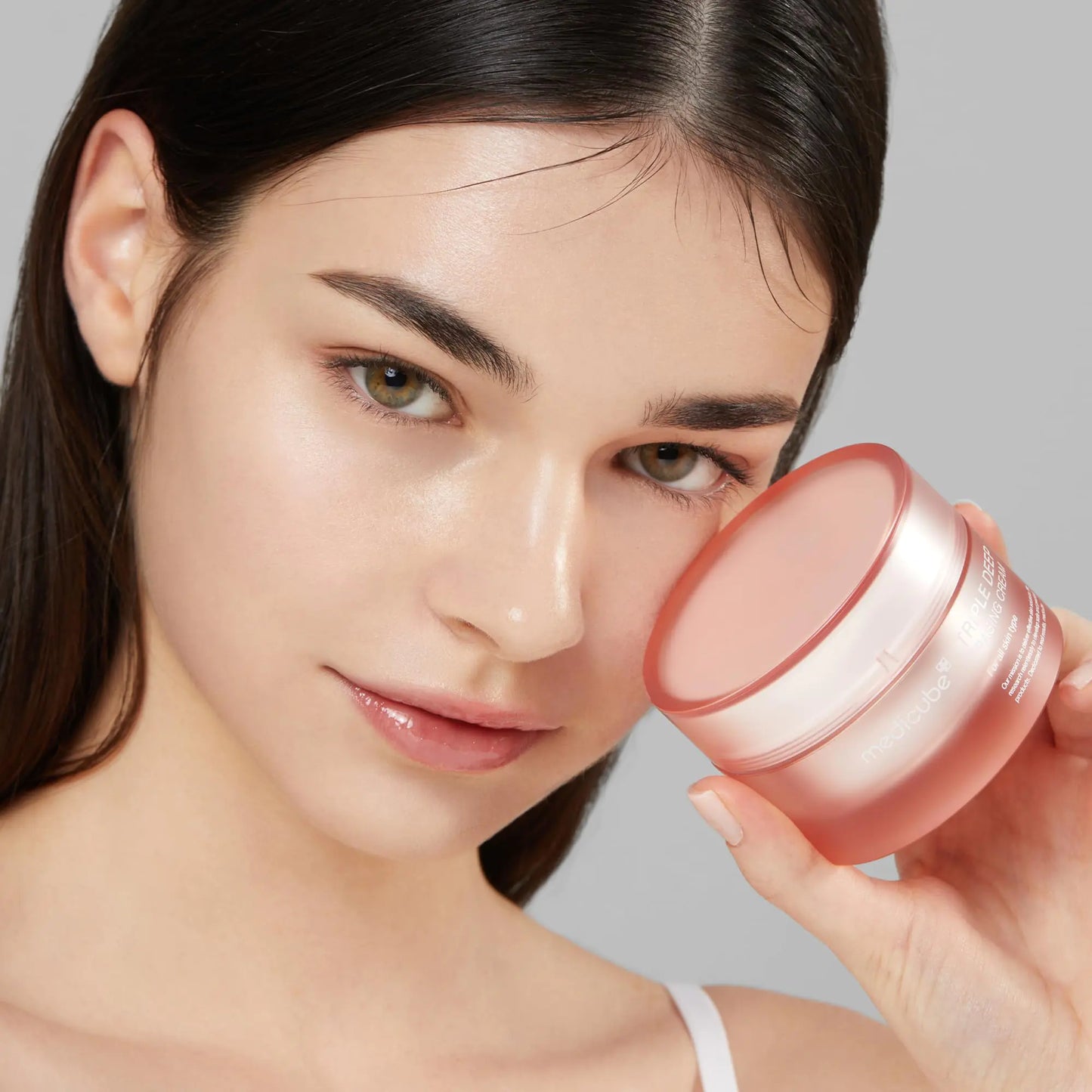 Beautiful clear Skin Lady holding the Medicube Triple Collagen Cream - Hydrating & Firming Moisturizer with Hyaluronic Acid, Premium Elastin, Shea Butter - Wrinkle Care & Boosts Elasticity - Korean Skincare, 1.69 oz - DivineLuxes