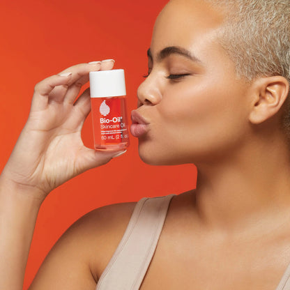 A lady holding and kissing the Bio-OIl Skincare C 